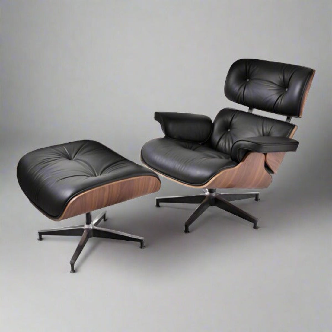 Black leather lounge chair and ottoman on a gray background