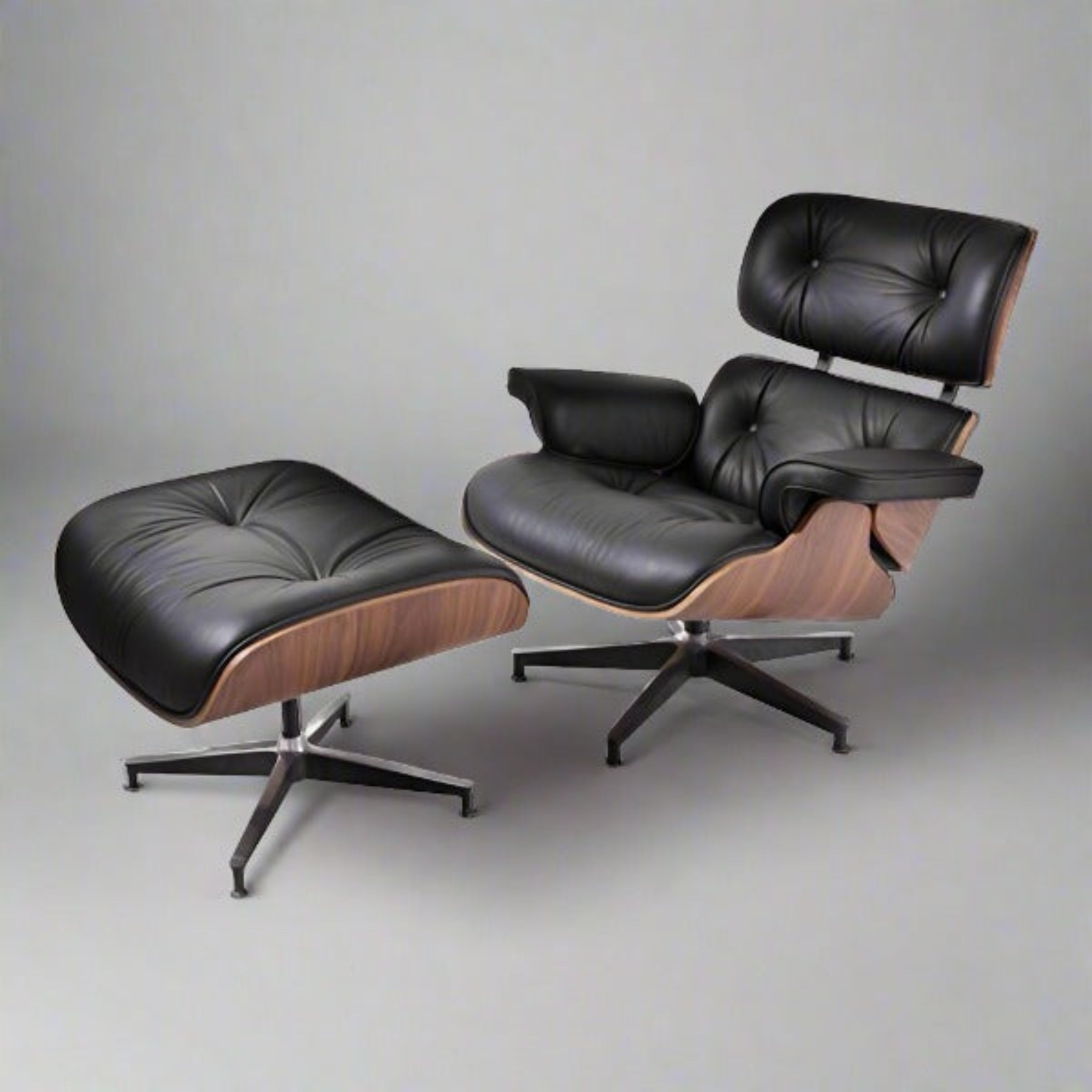Black leather lounge chair and ottoman on a gray background