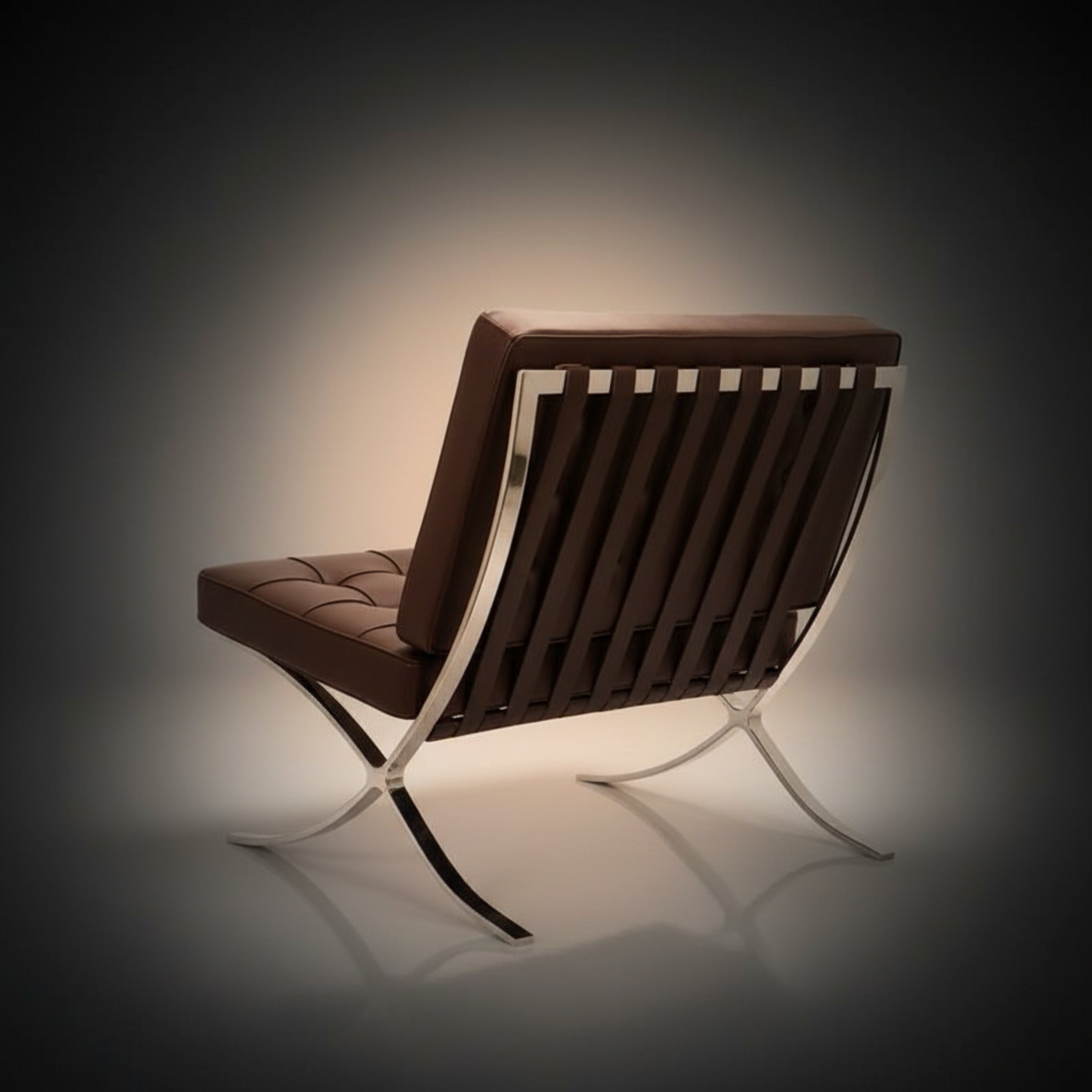 A modern brown leather lounge chair with a chrome slatted backrest and curved metal legs, shown from a three-quarters angle.