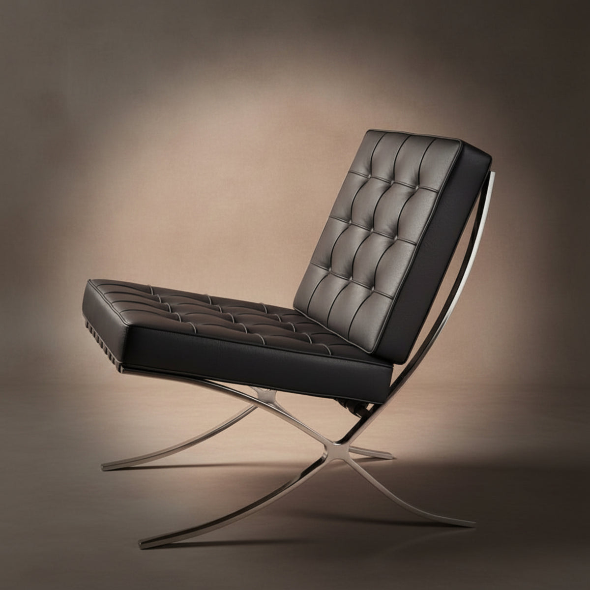 A modern leather lounge chair with a tufted black seat and backrest, supported by a curved polished metal frame
