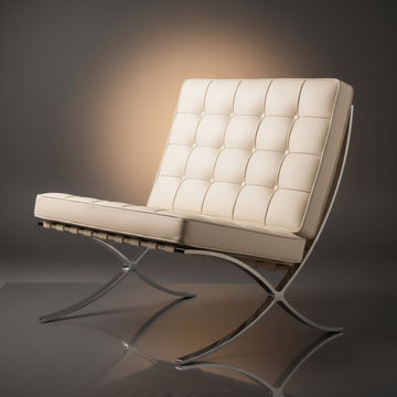 A modern tufted leather armchair with a chrome metal frame, shown on a dark gray reflective studio. 