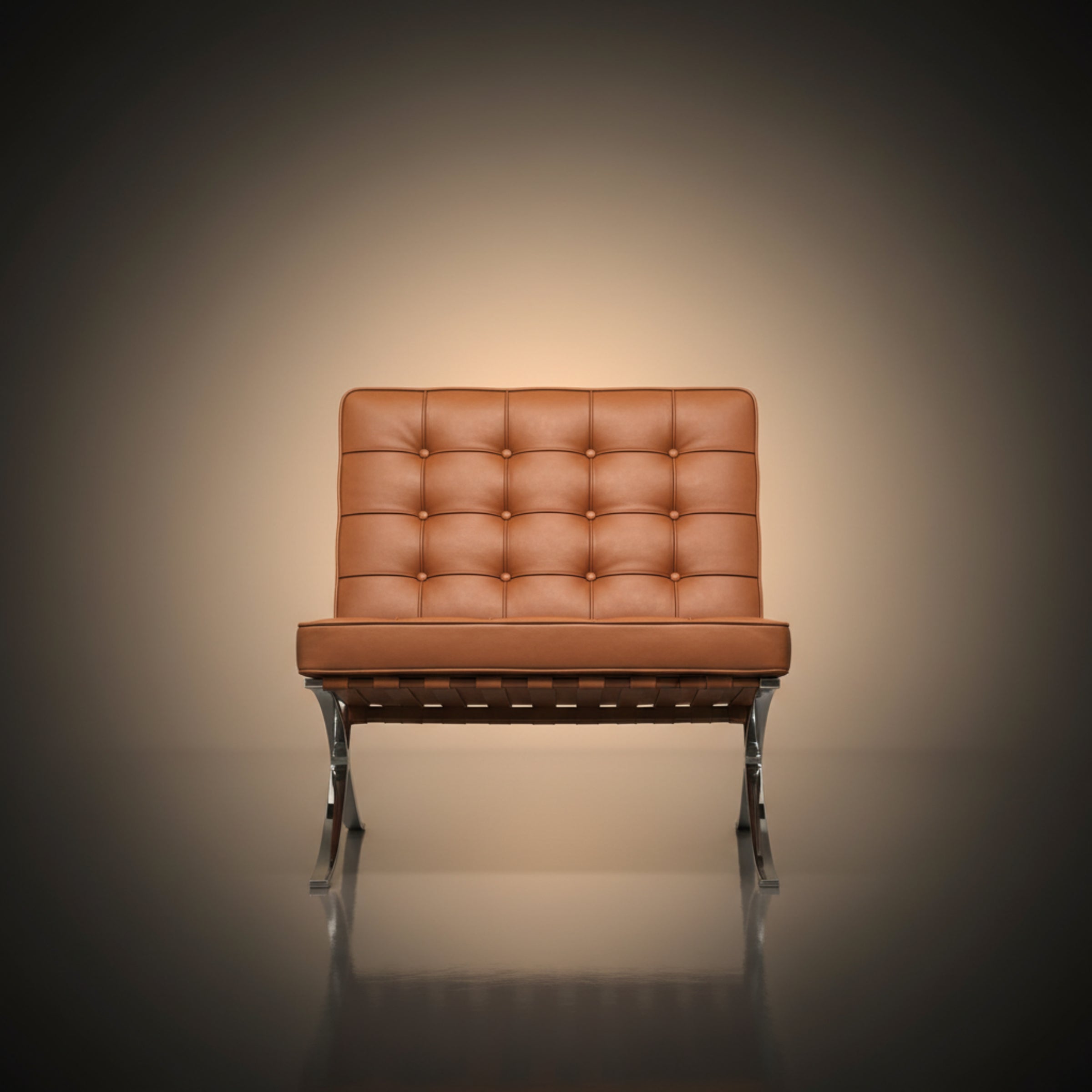 A modern leather armchair with a tufted backrest and chrome legs, centered against a dark vignette background with a warm spotlight effect.