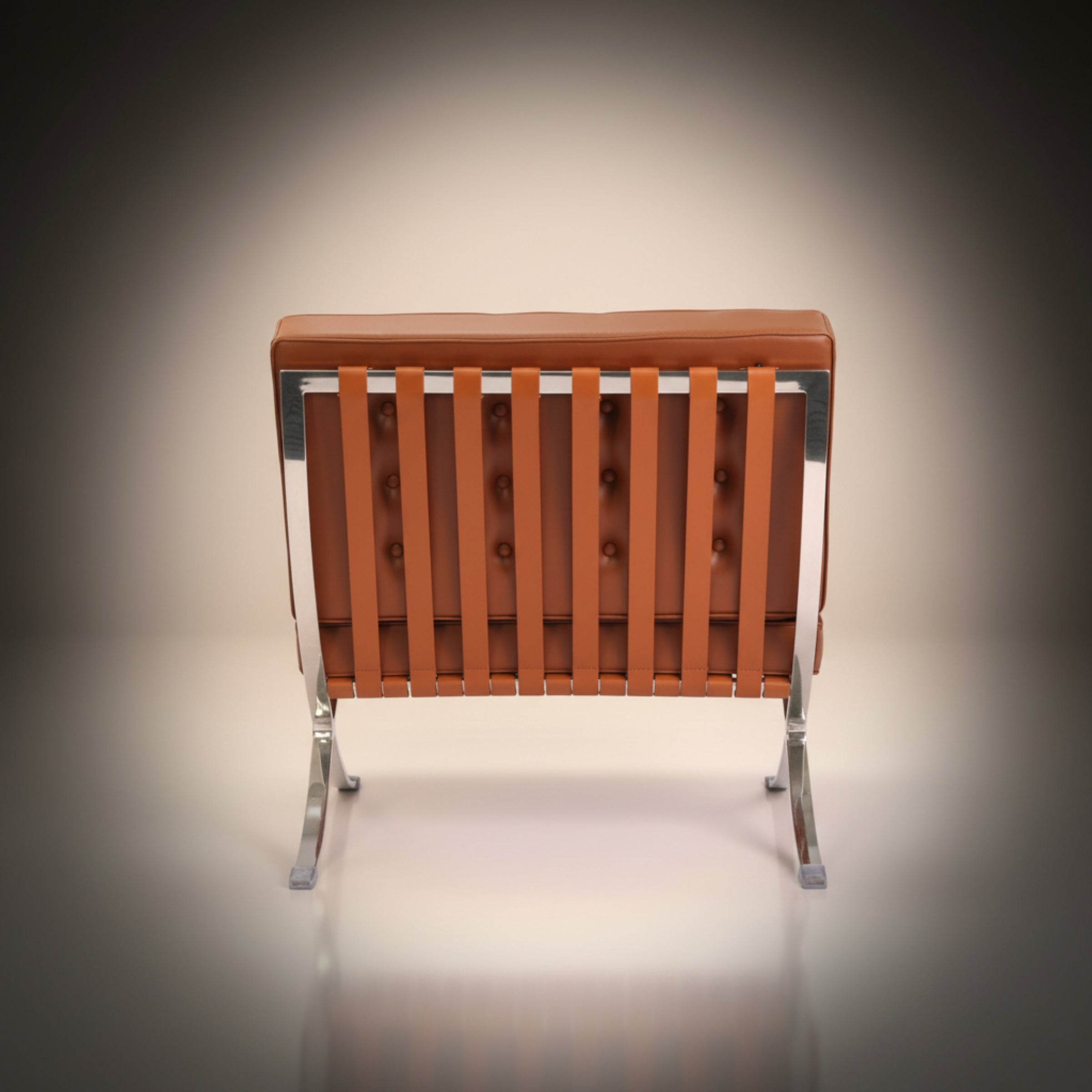 A modern lounge chair with a tufted brown leather backrest, vertical leather seat slats, and a chrome metal frame