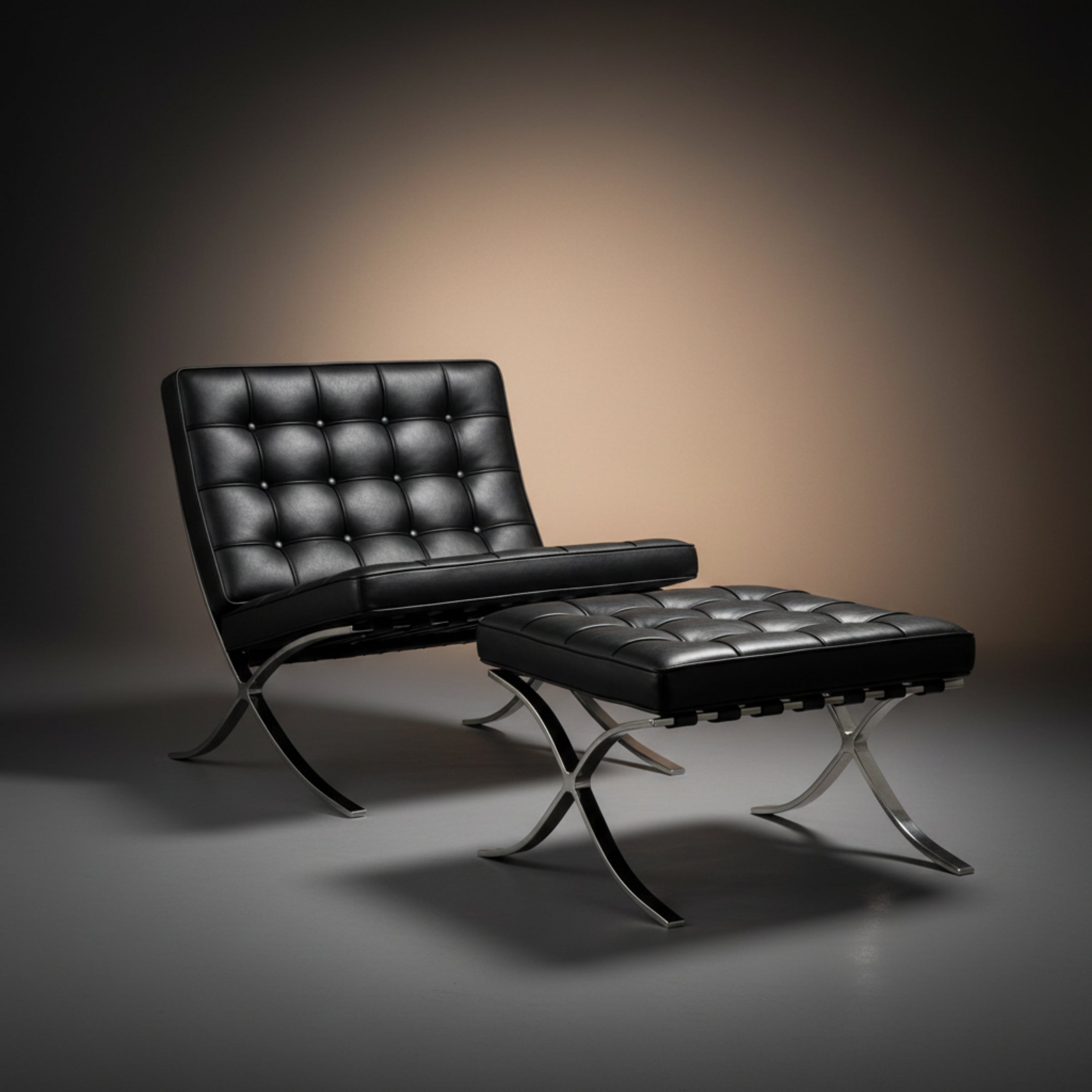 A black tufted leather lounge chair with a matching ottoman, both supported by chrome X-shaped metal legs