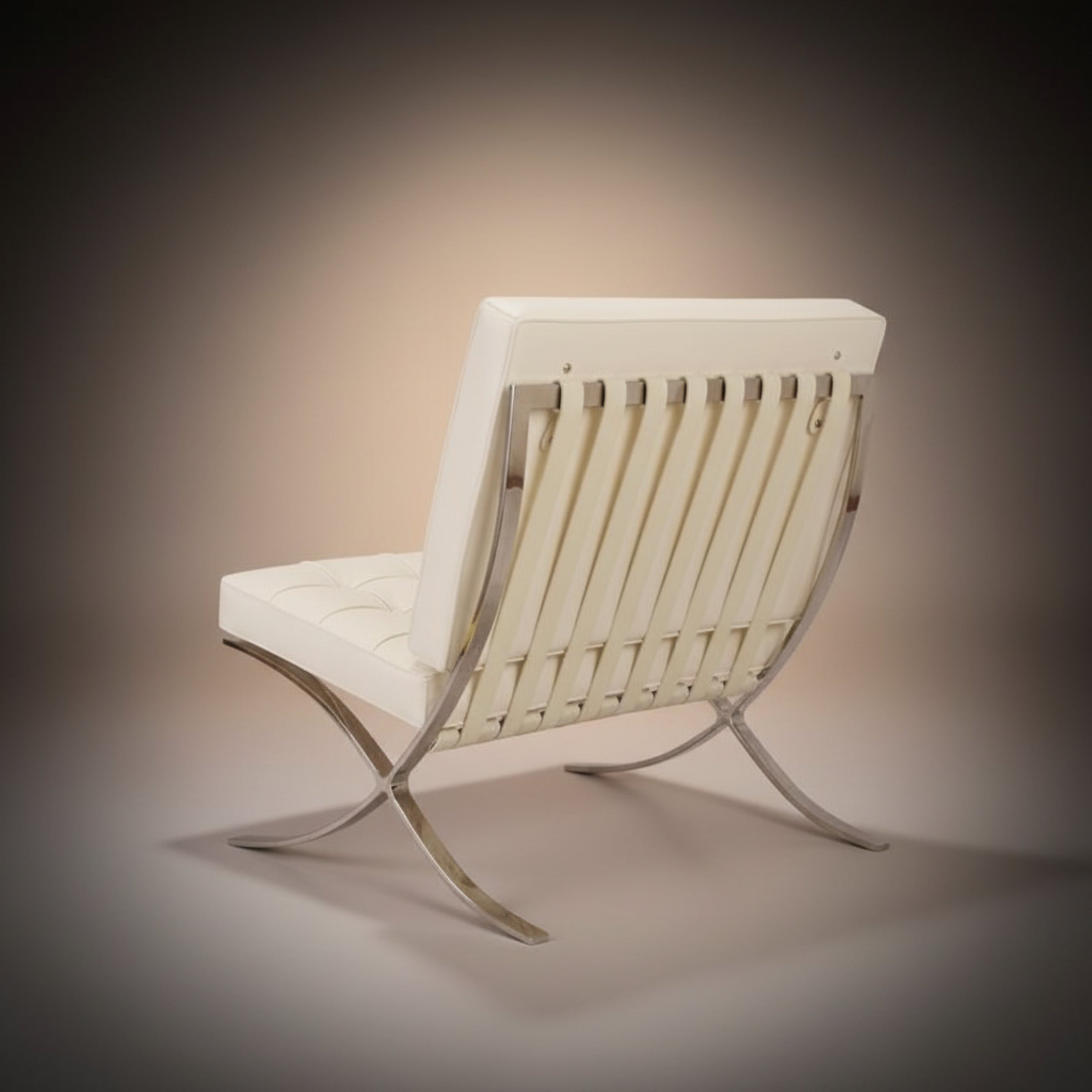 A modern lounge chair with a white upholstered seat and backrest, featuring vertical slats and a curved polished metal frame