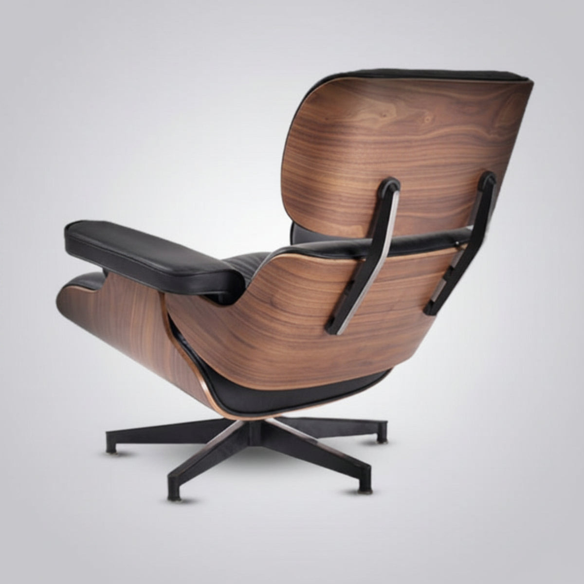 Black Italian leather Eames inspired lounge chair and walnut ottoman detail