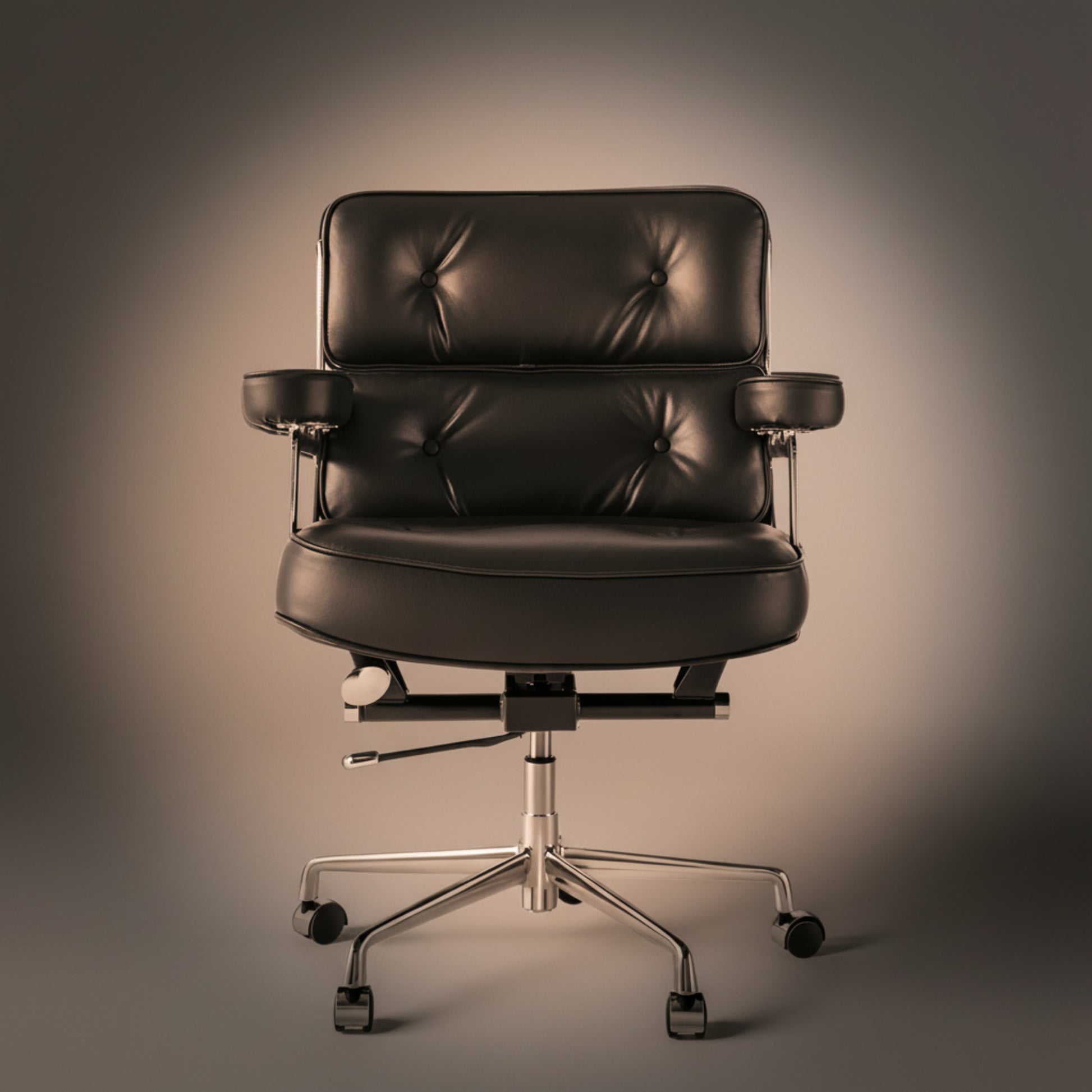 A black leather office chair with a tufted backrest, padded armrests, and a chrome five-star wheeled base.