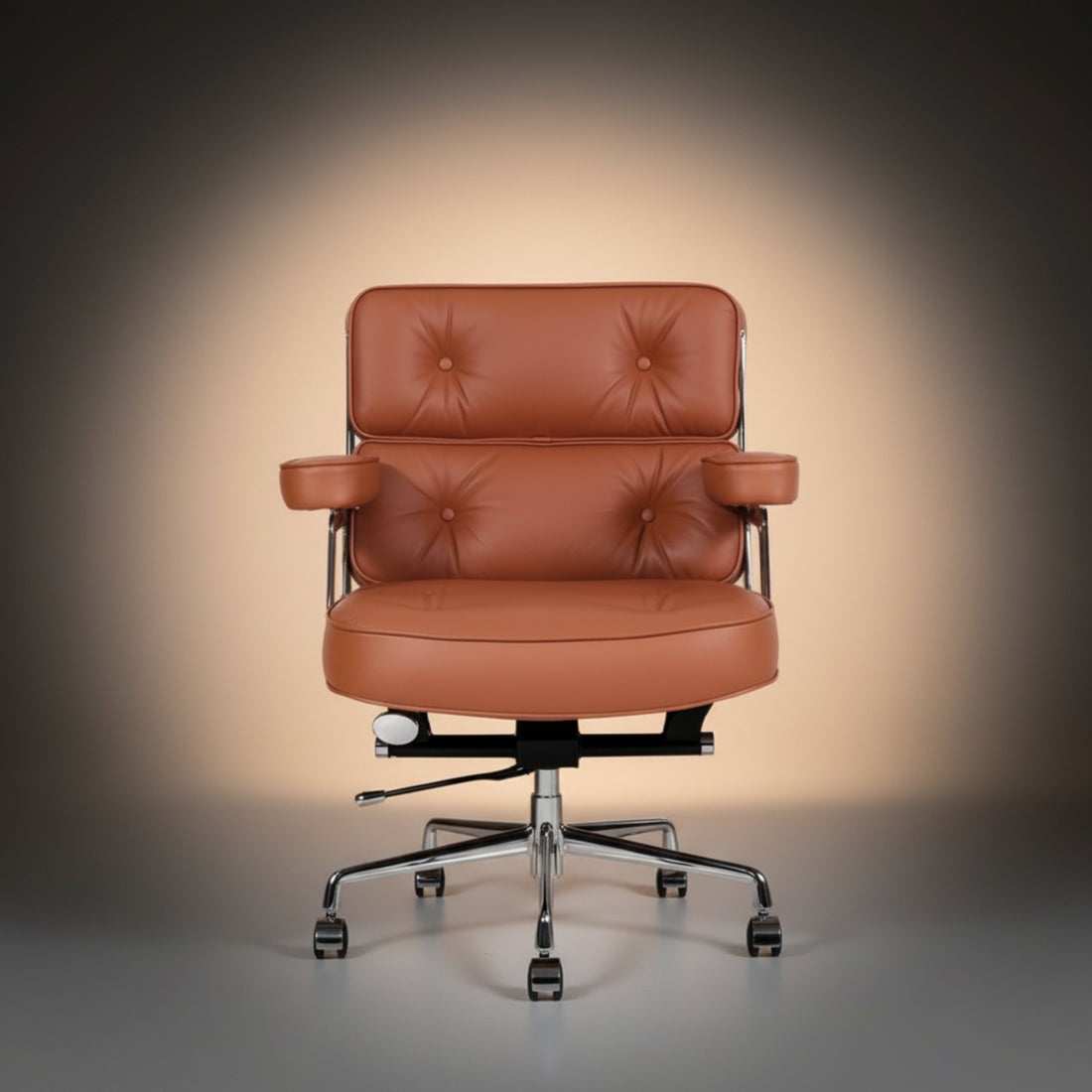 A mid-century modern office chair with tufted cognac brown leather upholstery and polished chrome metal armrests and base.