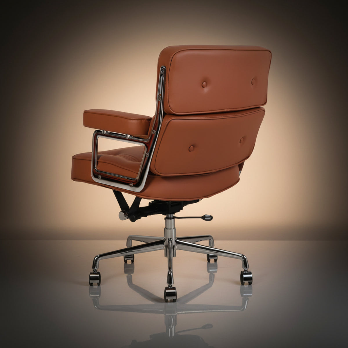 A mid-century modern style office chair with tan leather upholstery and a polished chrome five-star base.