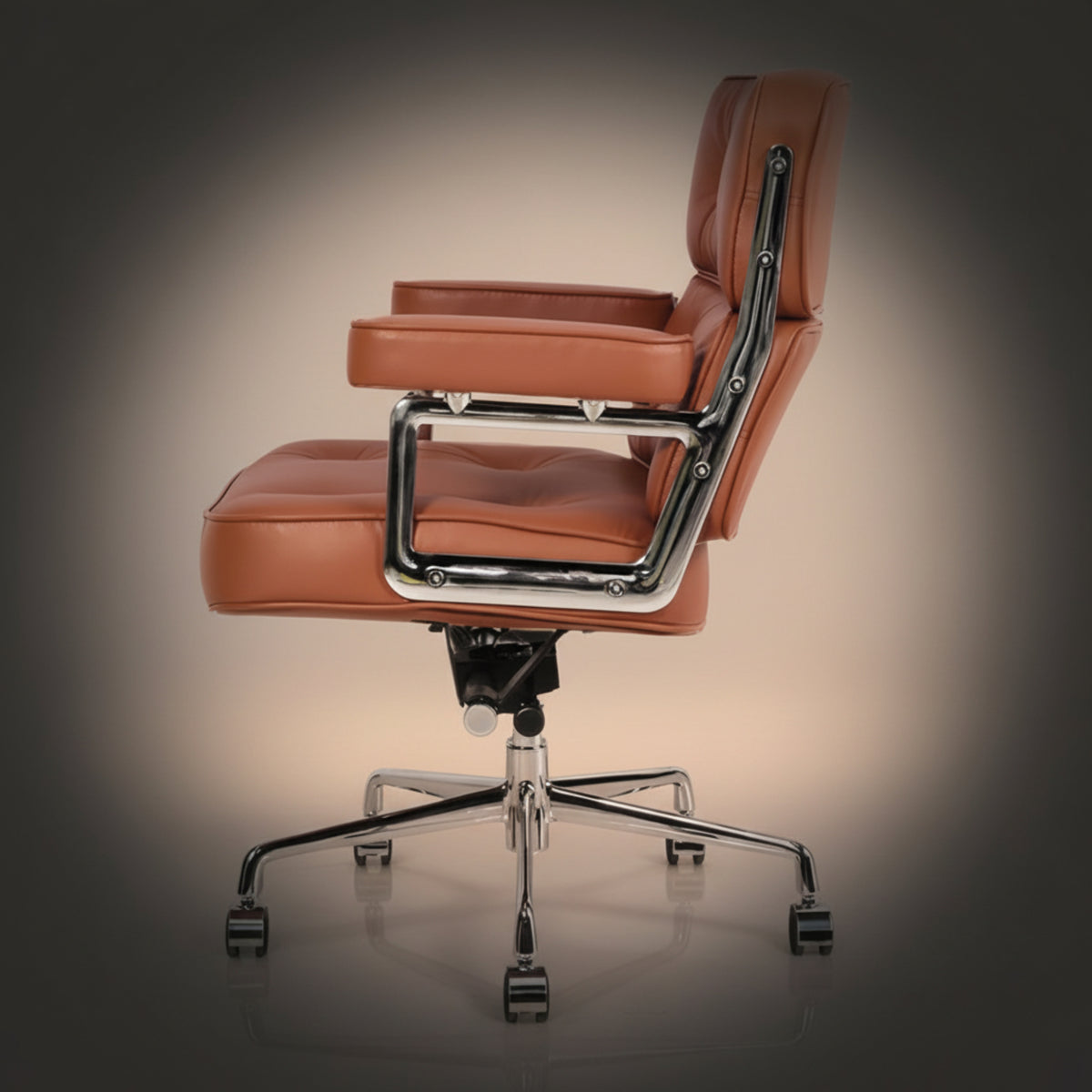 A mid-century modern office chair with tan leather upholstery and a polished chrome metal frame and five-star base.