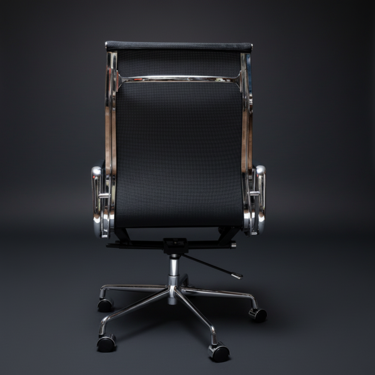 A modern office chair with a black textured mesh backrest, polished chrome metal frame.