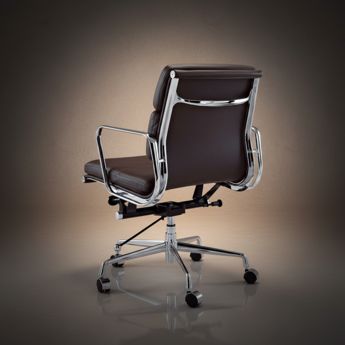 A modern office chair with dark brown leather upholstery and a polished chrome metal frame and base.