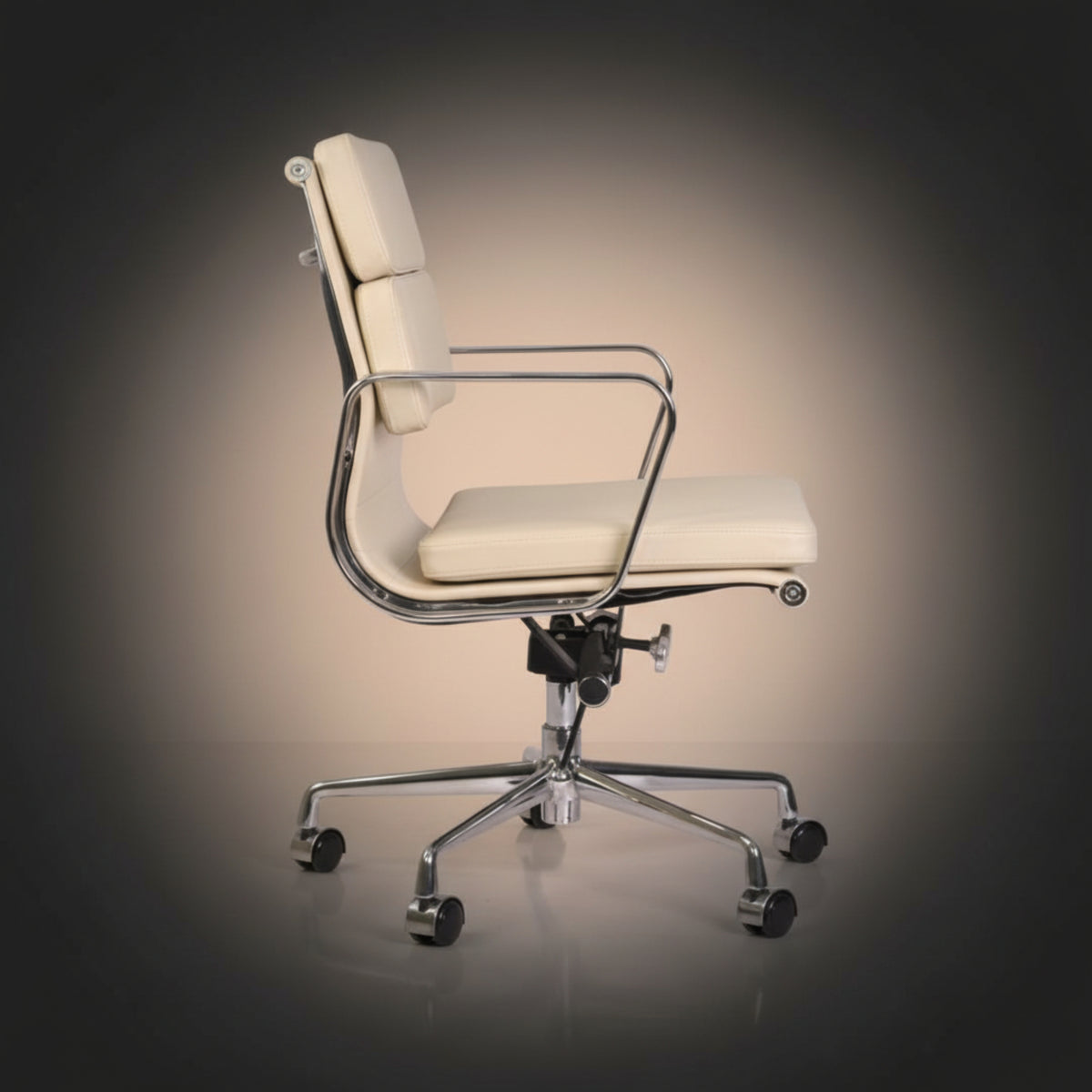 A modern office chair with cream-colored padded seat and backrest, supported by a polished chrome base