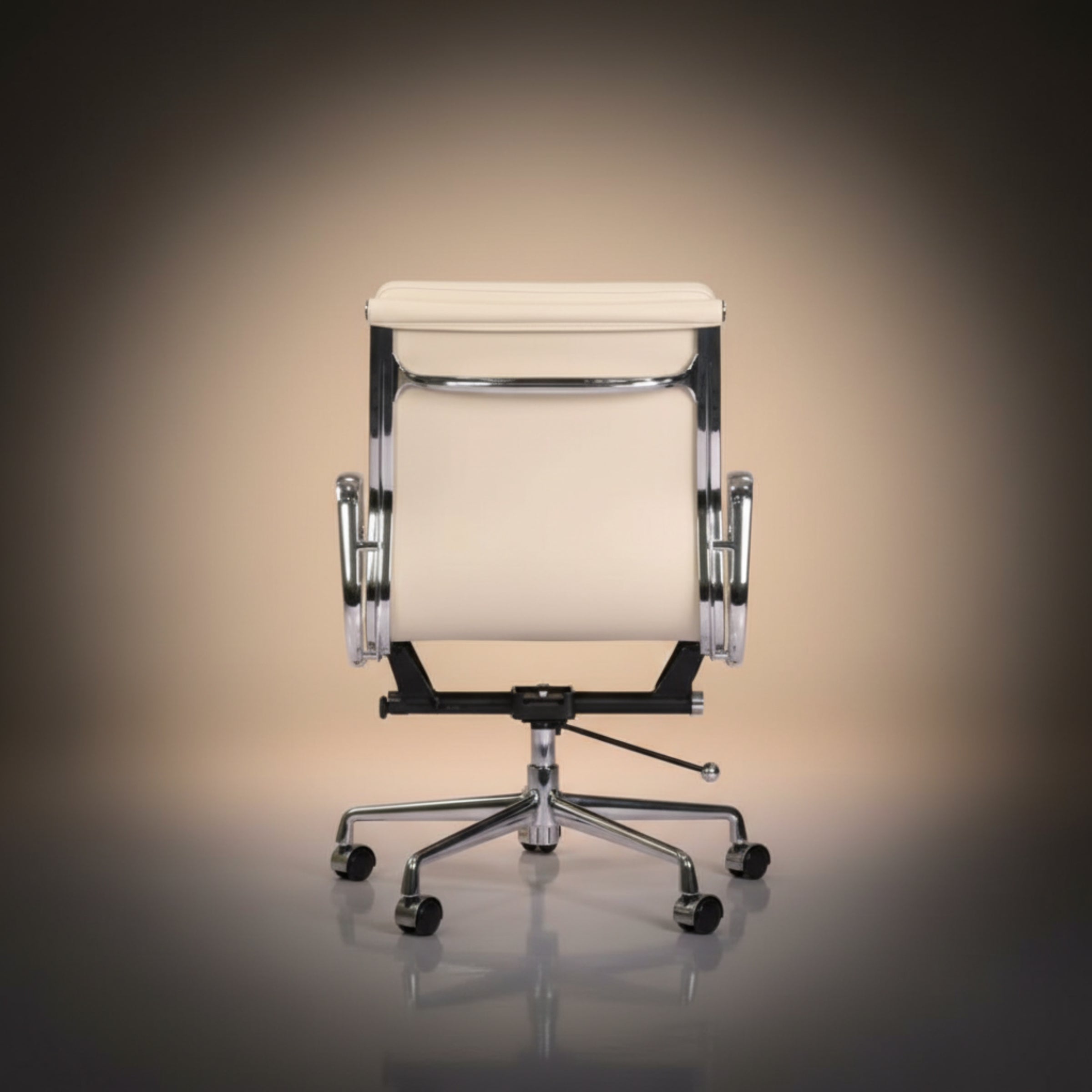 A modern office chair with a cream-colored upholstered seat and backrest, supported by a chrome base.
