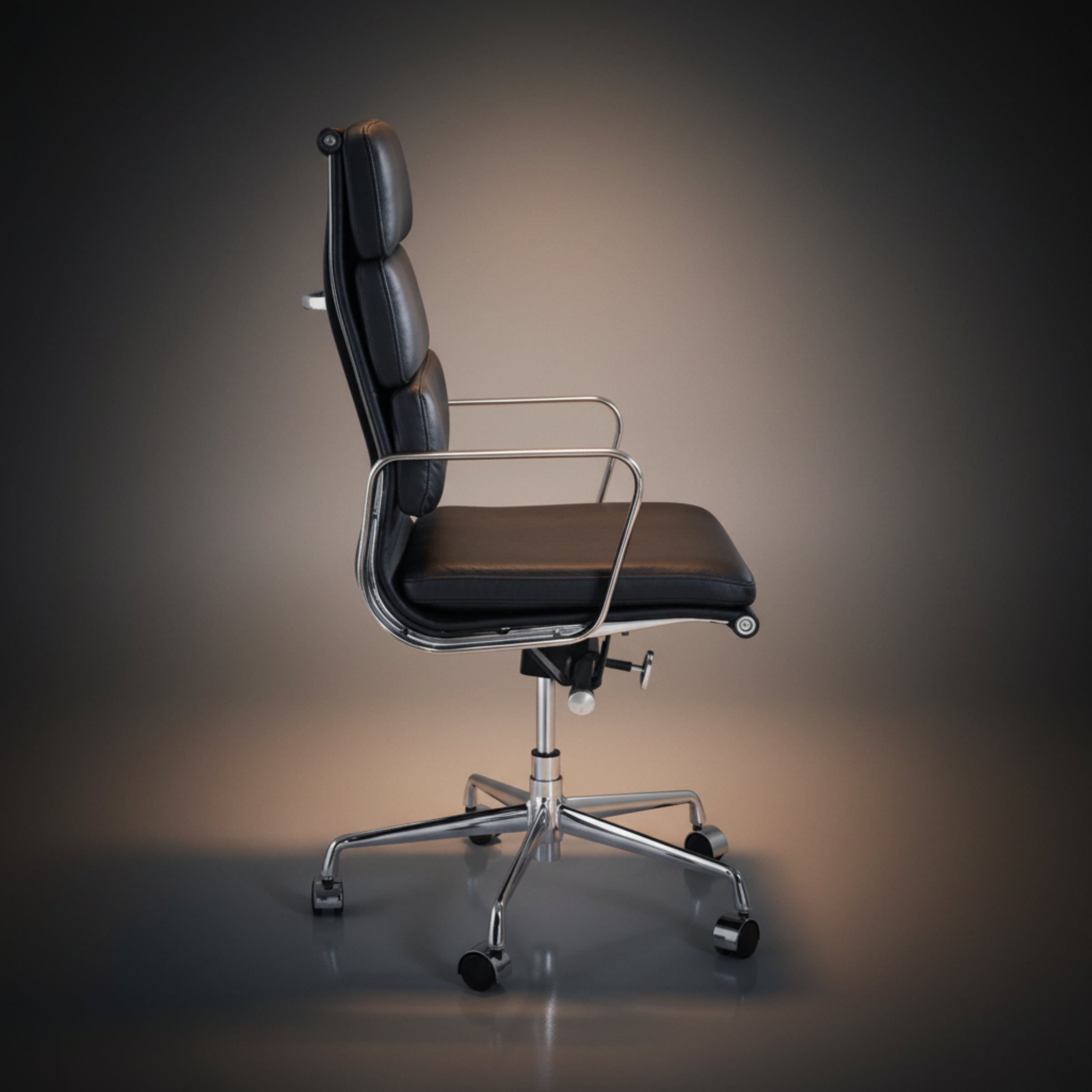 A modern black leather office chair with a high back, chrome metal armrests and base.