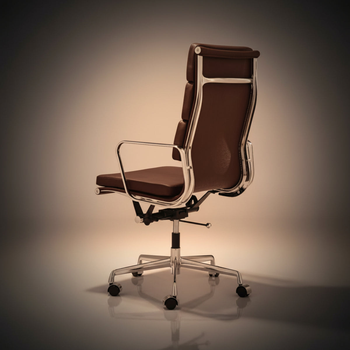 A modern high-back office chair with brown leather upholstery and a polished chrome metal frame.