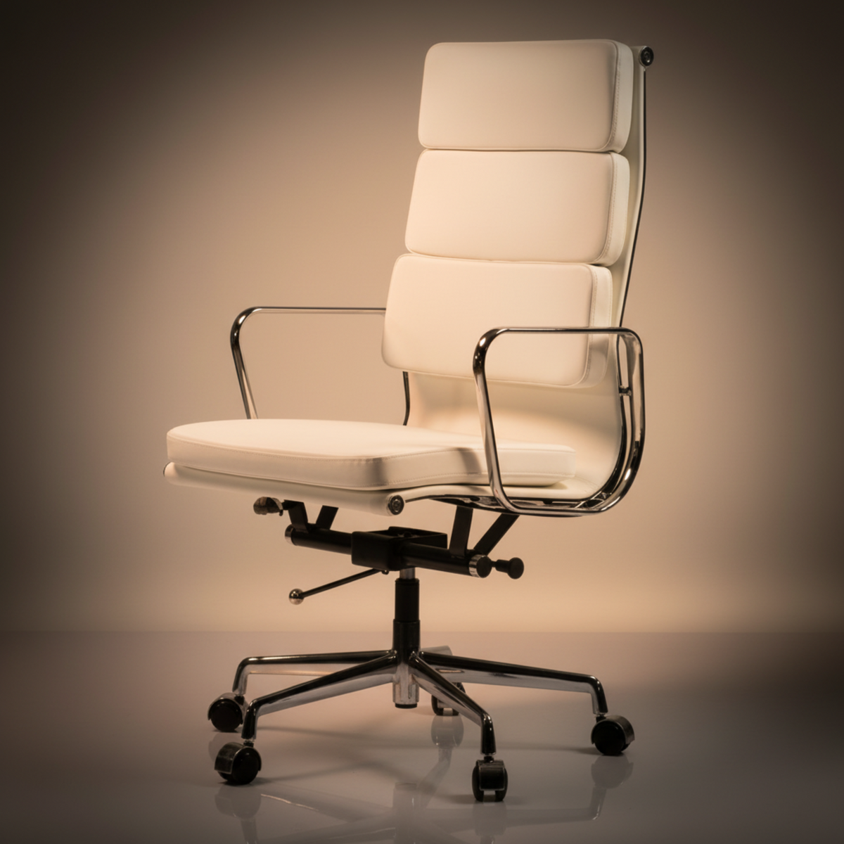 A modern high-back office chair with cream-colored padded upholstery and a polished chrome metal frame.